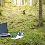 distance-job-work-office-with-laptop-and-tablet-in-a-mossy-green-forest-RY8Y33